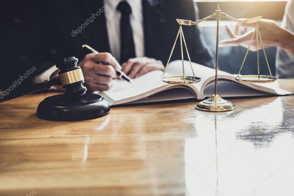 Male lawyer or Counselor working in courtroom have meeting with client are consultation with contract papers of real estate, Law and Legal services concept.