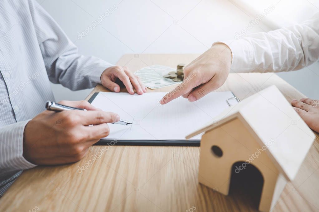 Business Signing and analyzing a contract buy - sell house, insurance agent analyzing cost about home investment loan Real Estate, Concept mortgage loan approval.