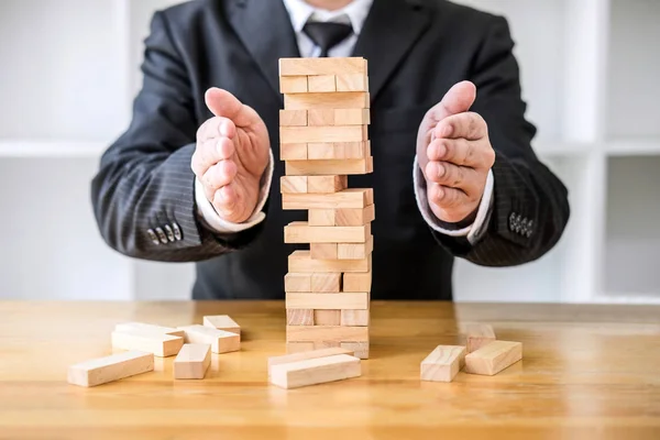 Alternative risk concept, plan and strategy in business protect with balance wooden stack with hand control risk shape.