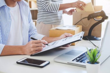 Küçük işletme sahibi teslimat servisi ve paketleme kutusu, işletme sahibi posta ofisine müşteri göndermeden önce kontrol emri için çalışıyor, Sevkiyat Çevrimiçi Satış.