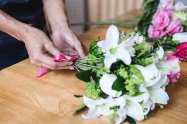 Yapay çiçek yeleği dekorasyon evde düzenlenmesi, Genç kadın çiçekçi iş DIY yapay çiçek, el sanatları ve el yapımı kavramı düzenleme yapma.