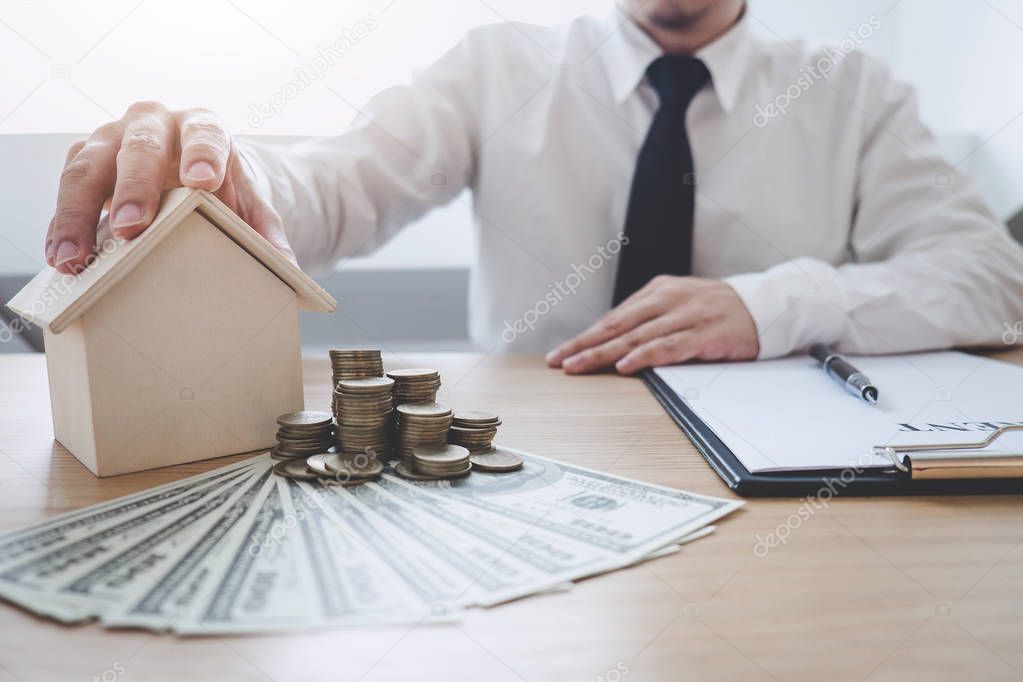 Business Financing Accounting Banking Concept, businessman doing finances and calculate about cost to real estate investment, Concept mortgage loan approval.