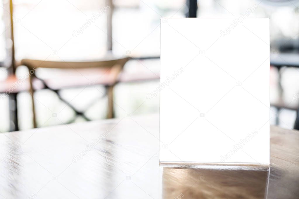Mock up blank menu frame on table in coffee shop stand for your text of display your product.