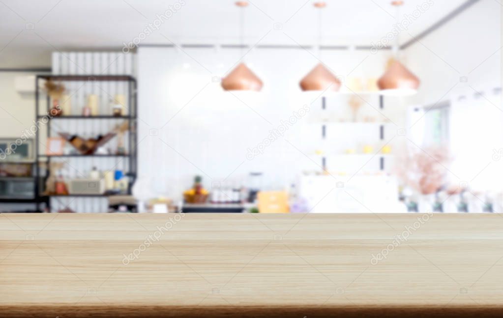 Empty wooden table and blurred background of abstract in front of coffee shop or restaurant for display of product or for montage.