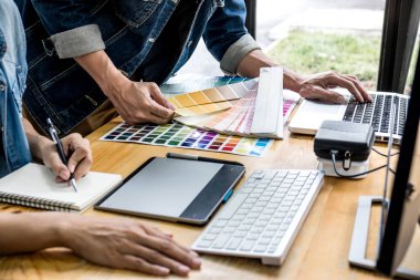 Genç yaratıcı bir toplantı yaratıcı ofis, iş araçları ve aksesuarları, renk renk örneği örnekleri grafik seçimi boyama çizim mimari sahip takım.