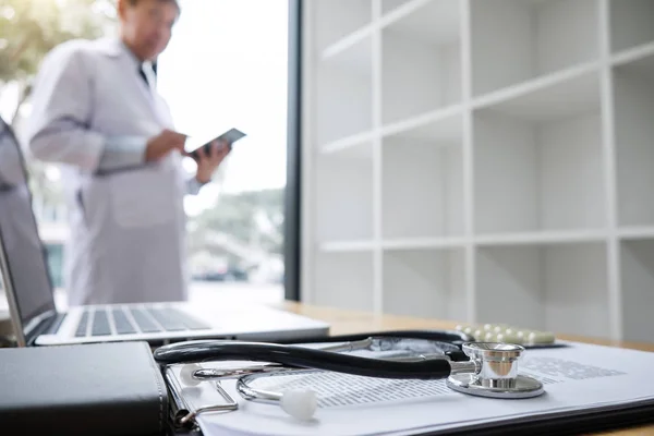 Close Stethoscope Blurred Doctor Checking Patient History Form While Think — Stock Photo, Image