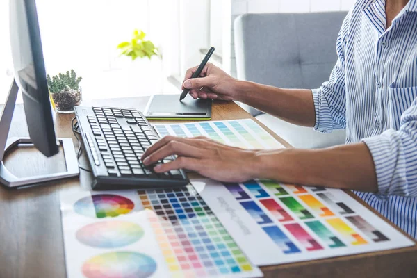 Image of male creative graphic designer working on color selecti