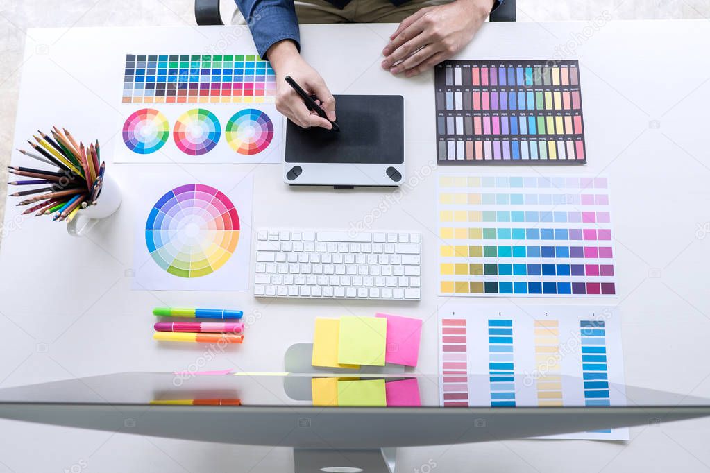 Image of male creative graphic designer working on color selecti