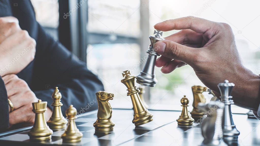 Two businessman playing chess game to plan strategy for success,