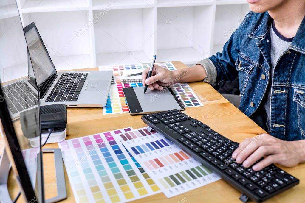 Image of male creative graphic designer working on color selecti