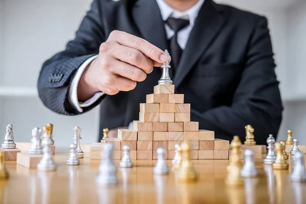 Wooden game of strategy, Hands of confident businessman playing — Stock Photo, Image