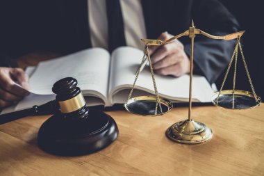 Erkek avukat ya da yargıç ile sözleşme kağıtları, hukuk kitapları çalışma ve