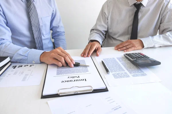 Real estate Sales manager giving keys to customer after signing