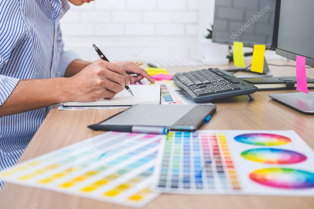Image of male creative graphic designer working on color selecti