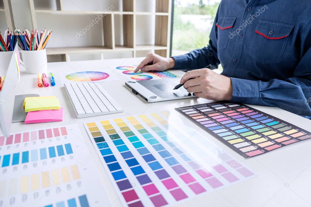 Image of male creative graphic designer working on color selecti