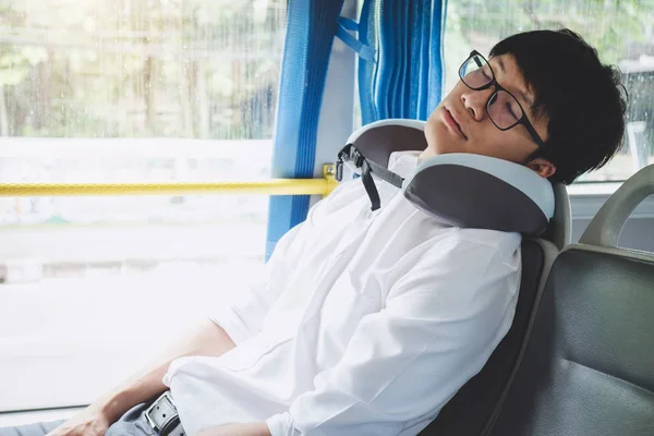 Young Asian man traveler sitting on a bus and sleeping with pill