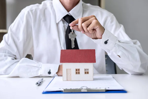 Real estate agent Sales manager holding filing keys to customer