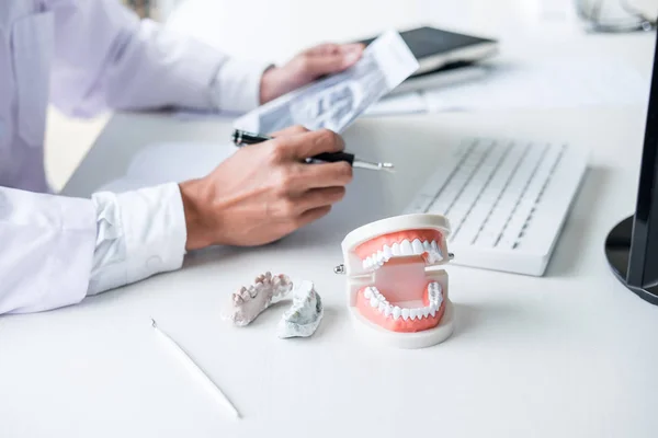 Male doctor or dentist writing report working with tooth x-ray f — Stock Photo, Image