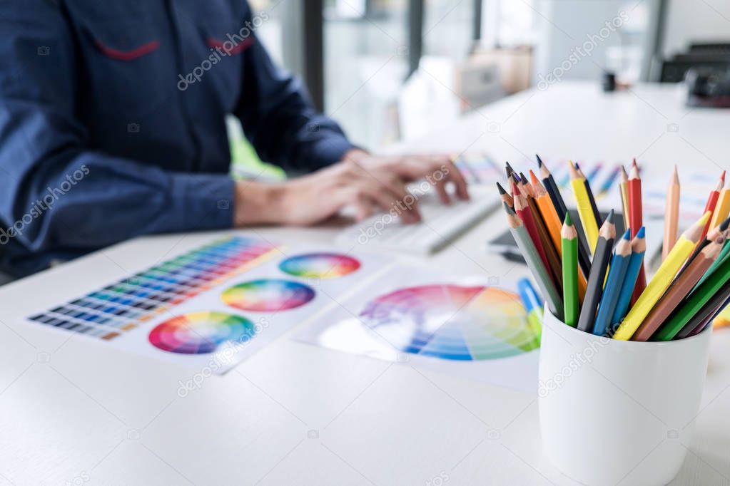 Image of male creative graphic designer working on color selecti