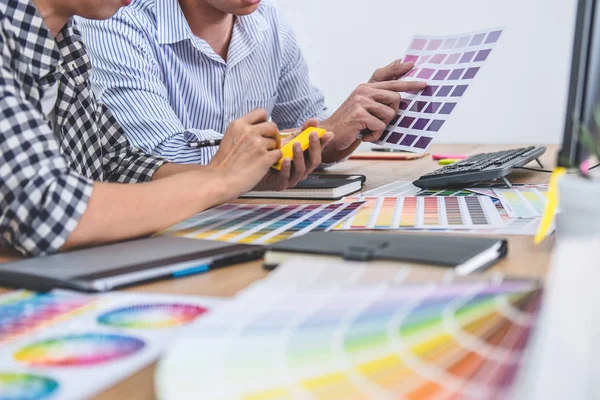 Two colleagues creative graphic designer working on color select