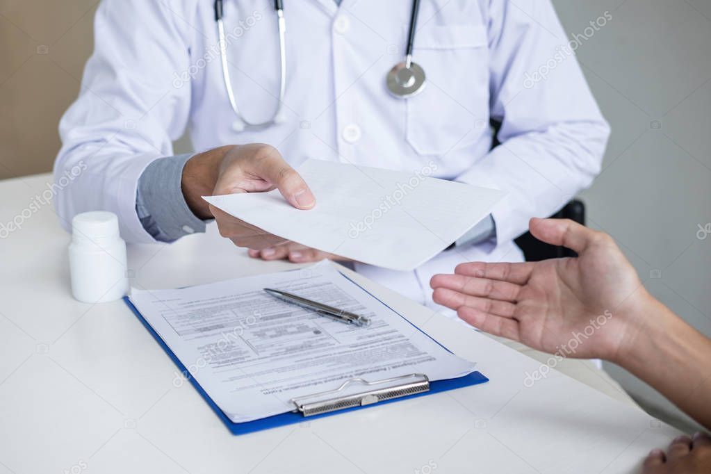 Doctor filling up an history form while consulting to patient an
