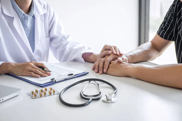 Doctor touching patient hand for encouragement and empathy in th — Stock Photo, Image