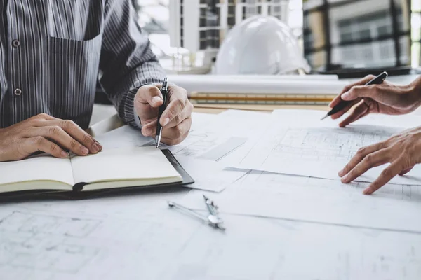 Hands of architect or engineer working on blueprint meeting for — Stock Photo, Image