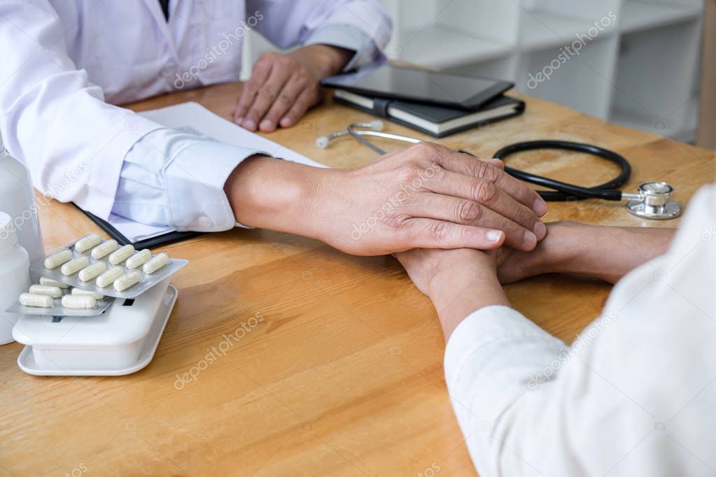 Professor doctor touching patient hand for encouragement and emp
