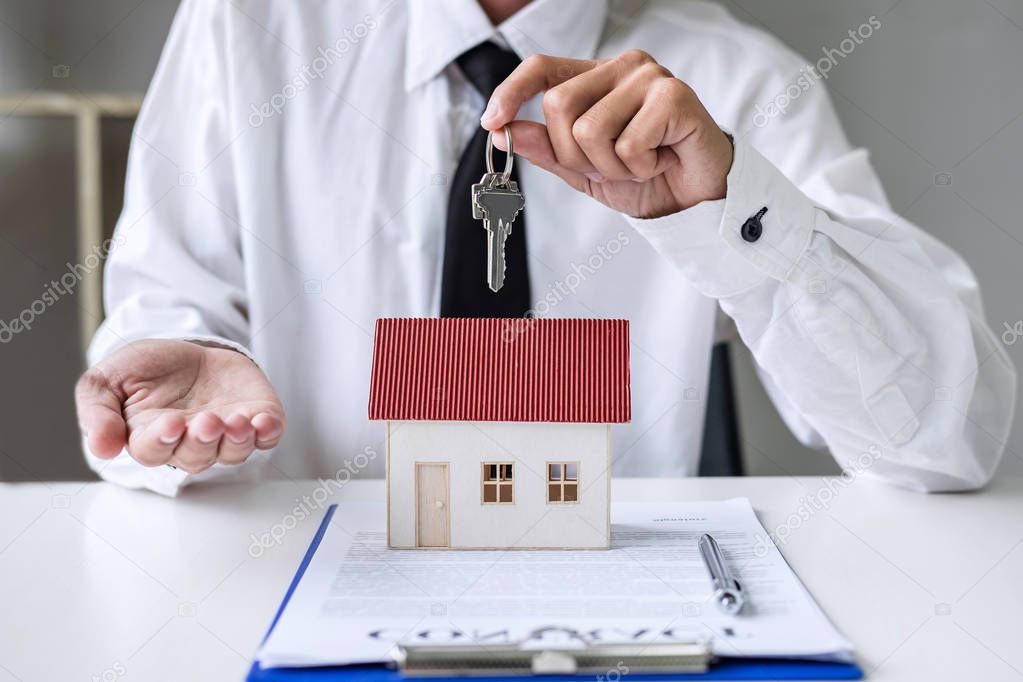 Real estate agent Sales manager holding filing keys to customer 