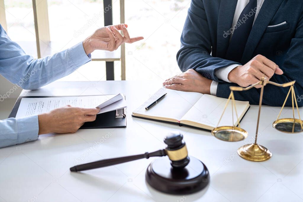 Businesswoman and Male lawyer or judge consult and conference having team meeting with client at law firm in office, Law and Legal services concept.