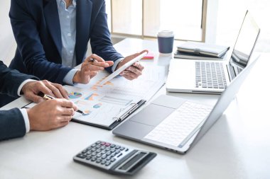 İş dünyası ekibi liderleri, meslektaşlarına sunum ve iş stratejisi üzerinde çalışıyor ve bir tartışma yapıyorlar, grafik ve grafiğe işaret ederek, işbirliği ortaklığının başarısına işaret ediyorlar..