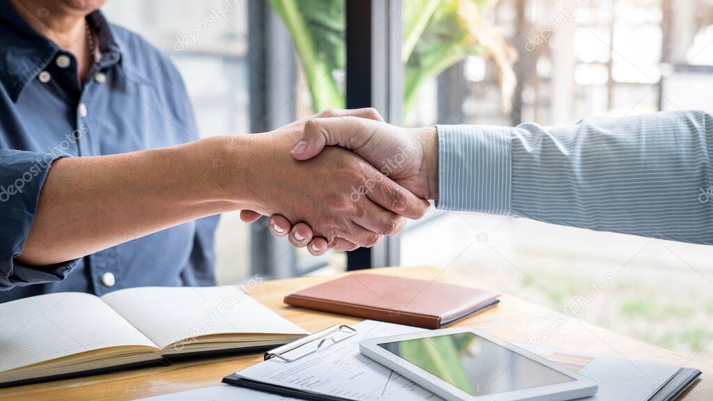 Successful of business deal, Business partnership meeting and handshake after discussing good deal agreement and become a partner of trading contract and new projects for both companies.
