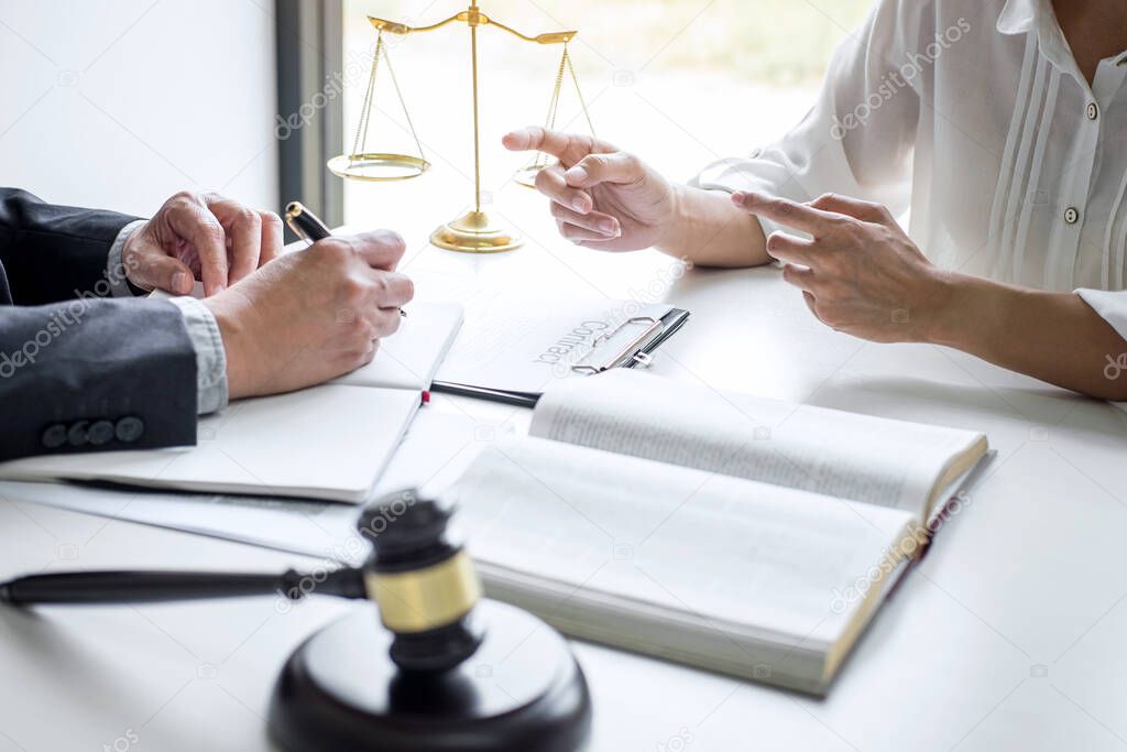 Consultation and conference of professional businesswoman and Male lawyers working and discussion having at law firm in office. Concepts of law, Judge gavel with scales of justice.