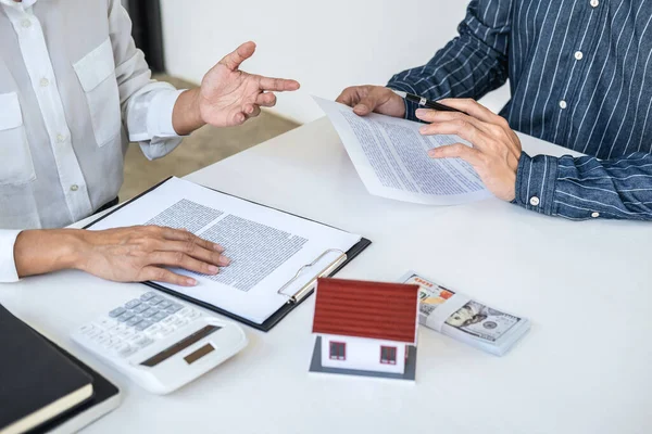 Real estate broker agent consult to customer to decision making sign insurance form and sending house model to client after approve, home model mortgage loan offer for and house insurance.