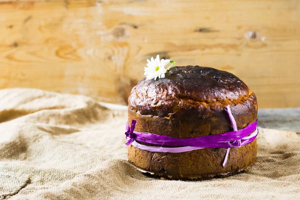 Easter sweet bread Orthodox kulich, paska, willow twigs. Easter Colorful eggs on wooden background. Easter. Holidays breakfast. Easter Palm Sunday. Space for text.