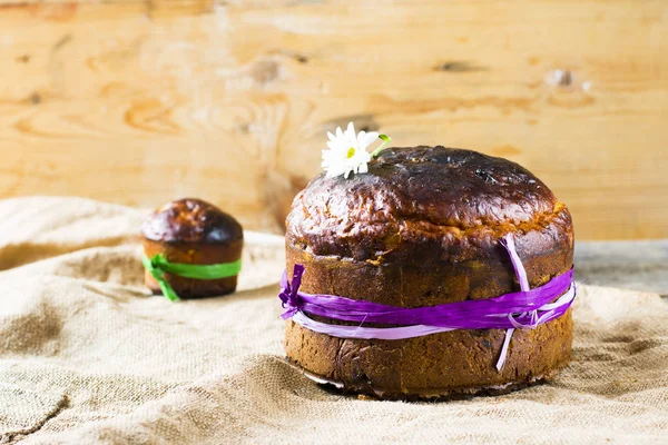 Easter sweet bread Orthodox kulich, paska, willow twigs. Easter Colorful eggs on wooden background. Easter. Holidays breakfast. Easter Palm Sunday. Space for text.