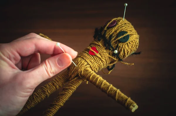 Hand and a voodoo doll during ancient ritual close-up — Stock Photo, Image