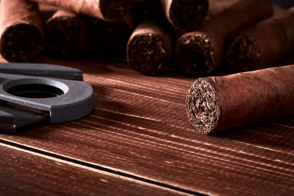 Still life with cuban cigars and cutter on old wooden board tabl — Stock Photo, Image