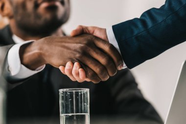 cropped shot of african-american businessmen shaking hand clipart