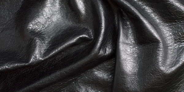 Background of black textured, glossy leather, rumpled, shiny fabric — Stock Photo, Image
