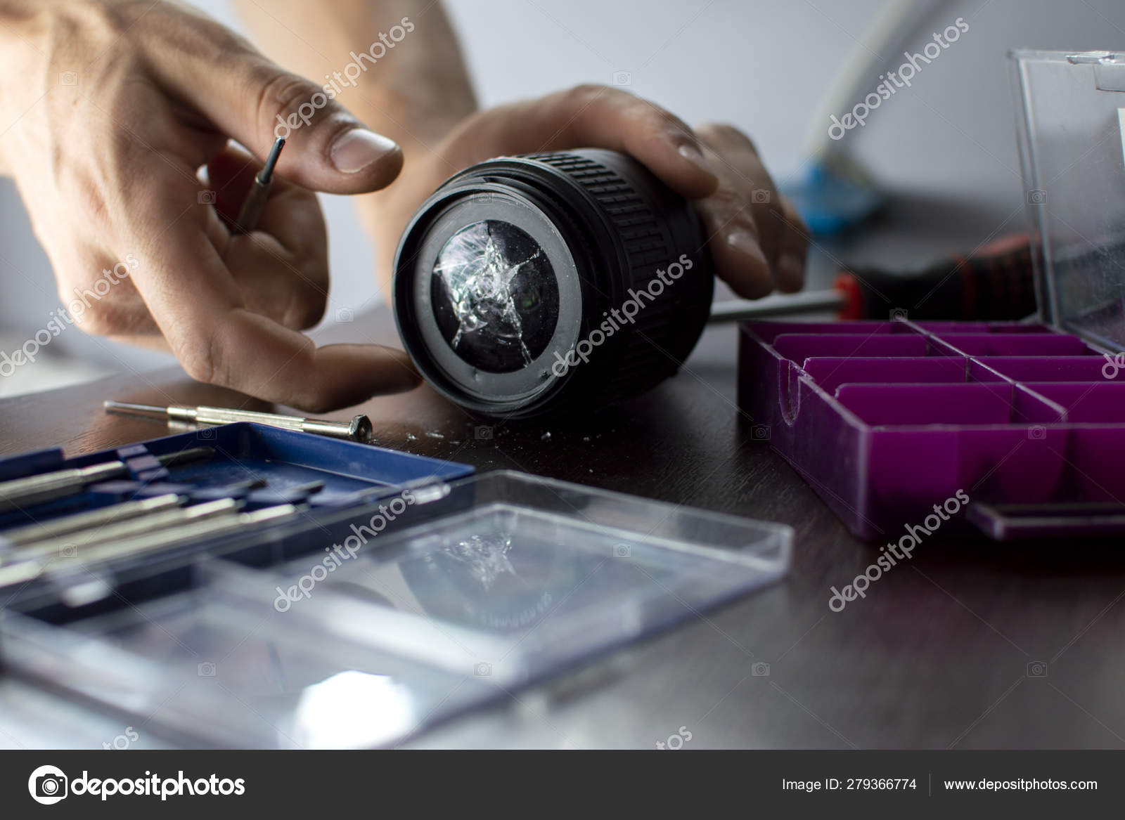 Broken Lens Lies On The Repair Table With Tools Close Up Of A Cracked Lens A Man Repairs Photo Equipment Stock Photo C Bogdanphoto 279366774