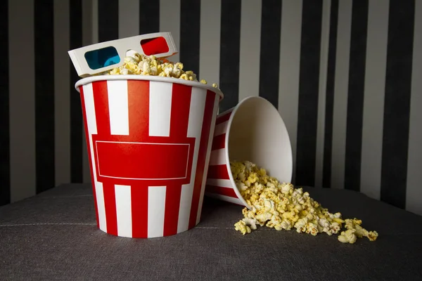 Two cardboard buckets of popcorn stand on a gray background with glasses, on the packs there is an copy space for text — Stock Photo, Image