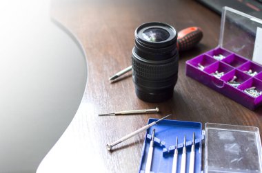 kırık lens araçları ile onarım masasında yatıyor, kırık bir lens yakın çekim, metin için kopya alanı