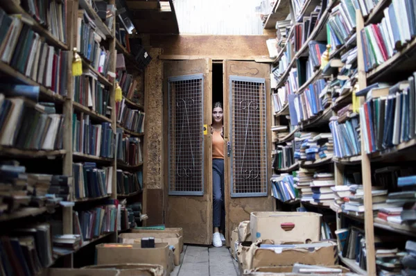 girl student goes into the library for books, she opens the door, education concept