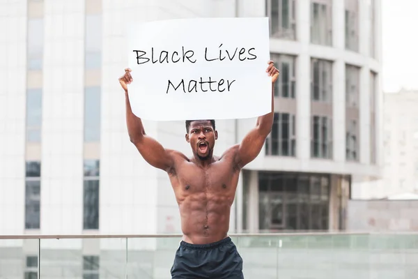 black lives matter concept. aggressive African American with a poster protests and shouts, Americans patriot activist rebellion, copy space