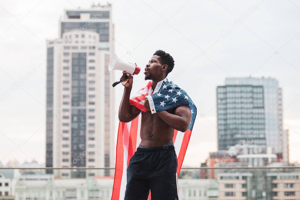 black lives matter concept. Aggressive african american guy with usa flag protests and shouts, patriot activist of america makes rebellion, copy space