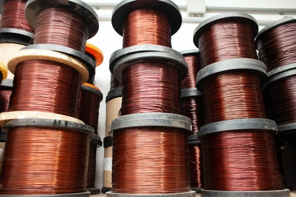 many different coils of copper wire in the production workshop, winding copper cable on spools