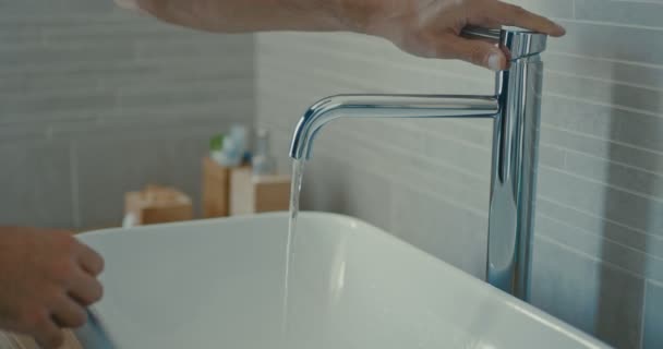 Imágenes de alta calidad de 4k 12bit. Cuidado corporal. Persona lavando las manos en el baño de diseño moderno en casa. Hombre lavando la mano masculina con jabón y agua bajo el grifo en el baño moderno — Vídeo de stock