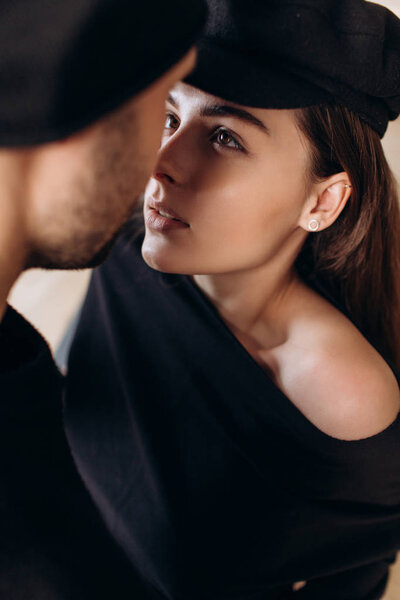 Close-up of young romantic couple is kissing and enjoying the company of each other at home.