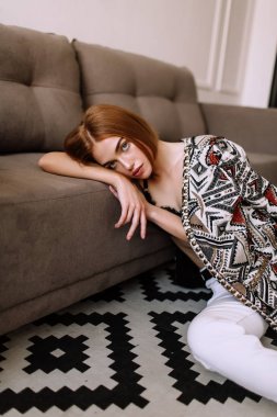 Güzel tatlı kız profesyonel kamera poz. Kısa kırmızı saçlı altın şık model, dolgun dudaklar, rahat giyim, kostüm, kıyafet, sütyen. Model testi, giyim reklam